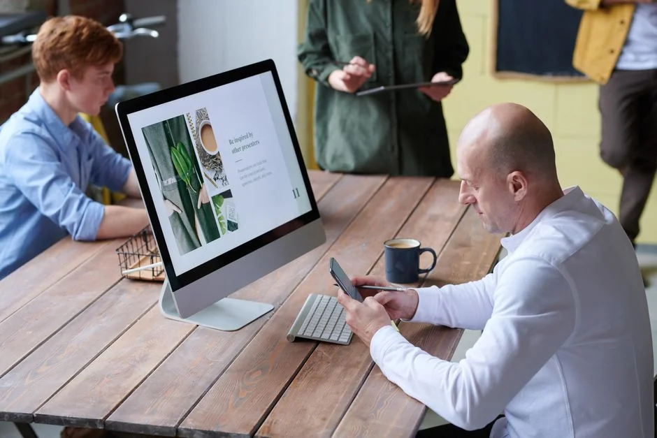 A stylish workspace featuring a laptop and monitors displaying design software.